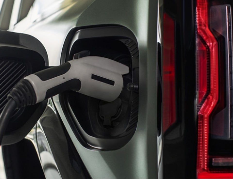 Close up of charging port with charger plugged in on a GMC Hummer EV SUV - Thornhill GM Superstore GMC in Chapmanville WV